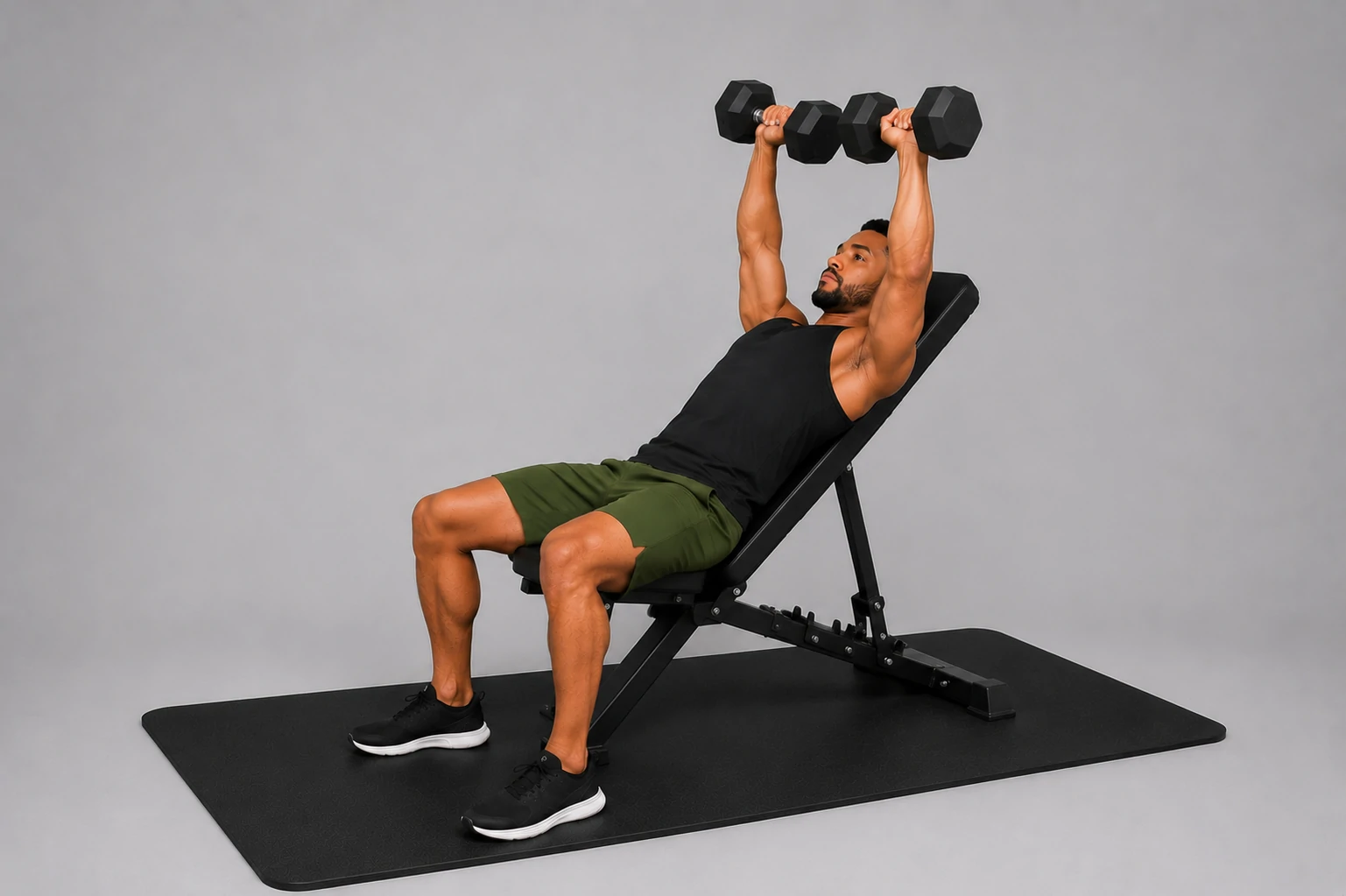 Incline dumbbell press top position with dumbbells pressed above the chest